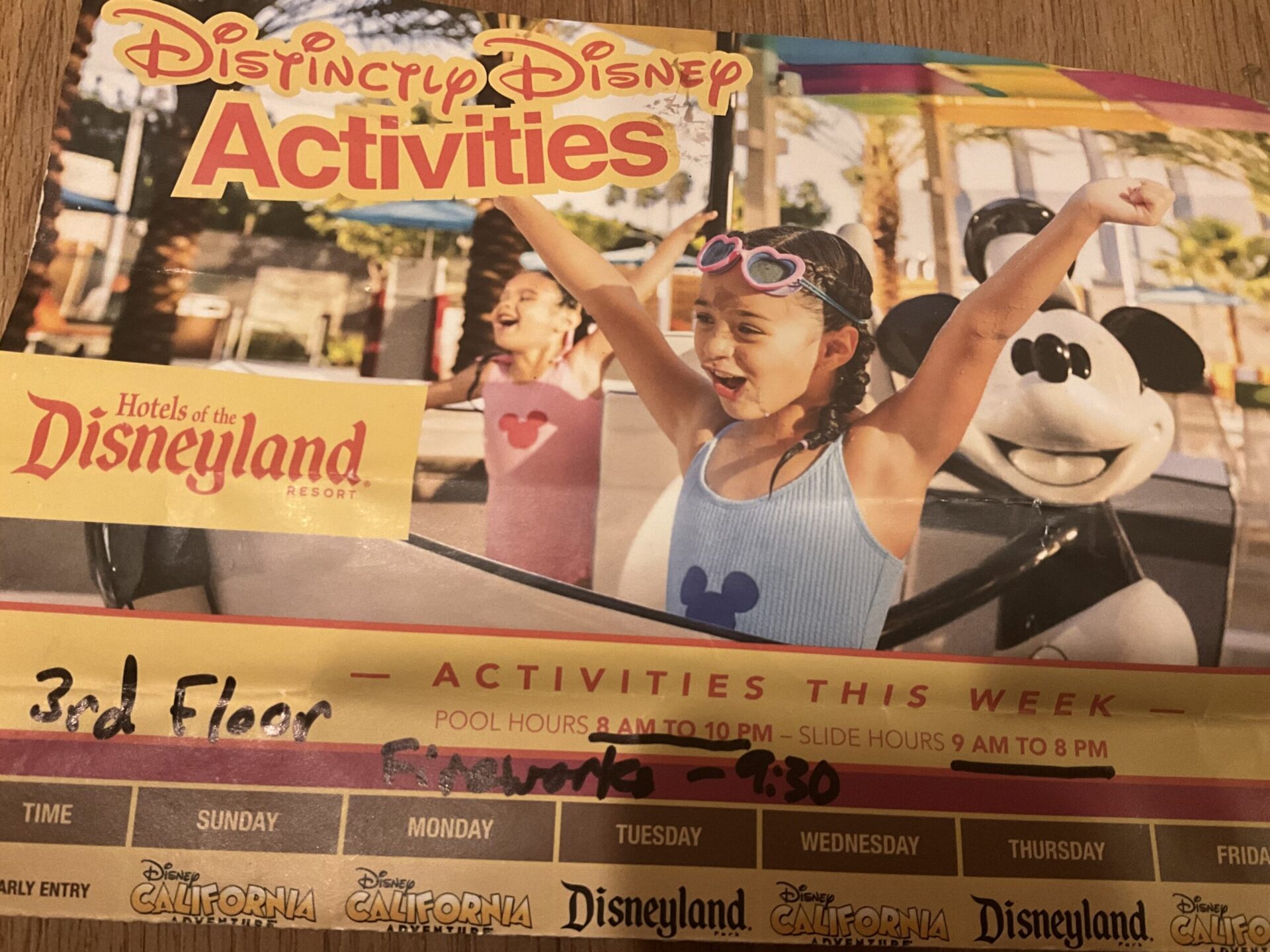 Photo of activity and entertainment guide from Disneyland Resort Hotels. Show schedule for the week and additional handwritten tips from a Disneyland cast member to demonstrate how to make the most of a stay at a Disneyland Resort Hotel.