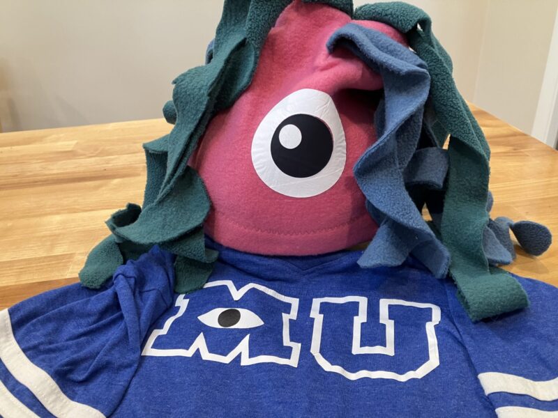 Close-up of Monsters Inc eye hat for comfortable and easy DIY costume for Disneyland and Halloween. Pink fleece hat with blue and green tentacles and iron-on vinyl eye.