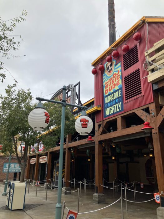 Photo of building facades in San Fransokyo Square in Disney California Adventure Park. Shows decor representing the Big Hero 6 franchise with the fusion of design elements from San Francisco and Tokyo.