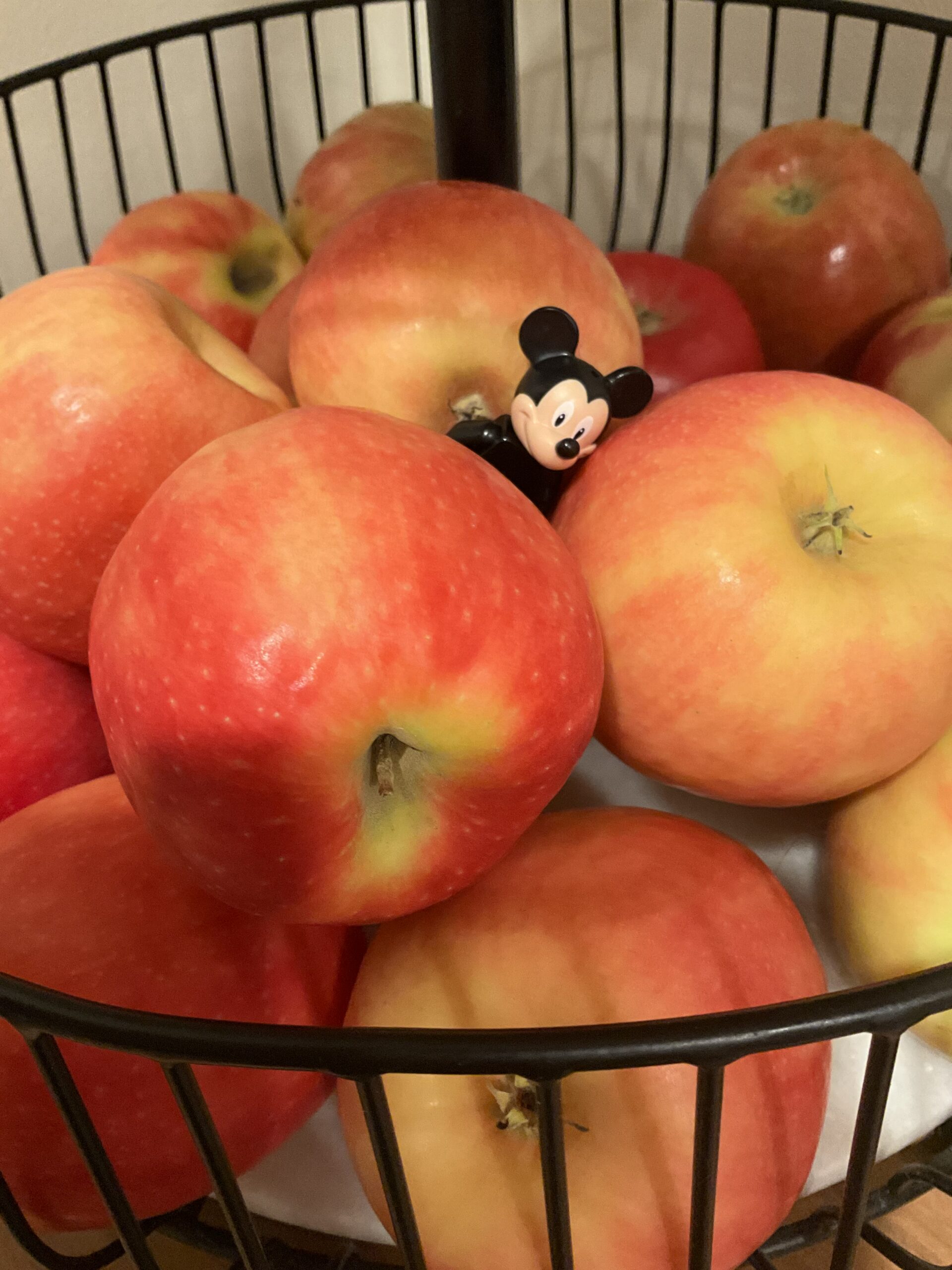 Mickey Lego figure in a bowl of apples.