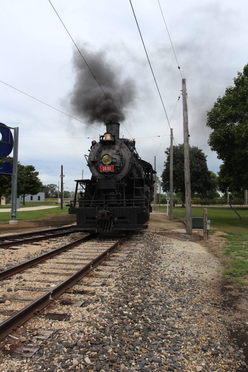 Black steam locomotive on main lane at Illinois Railway Museum.