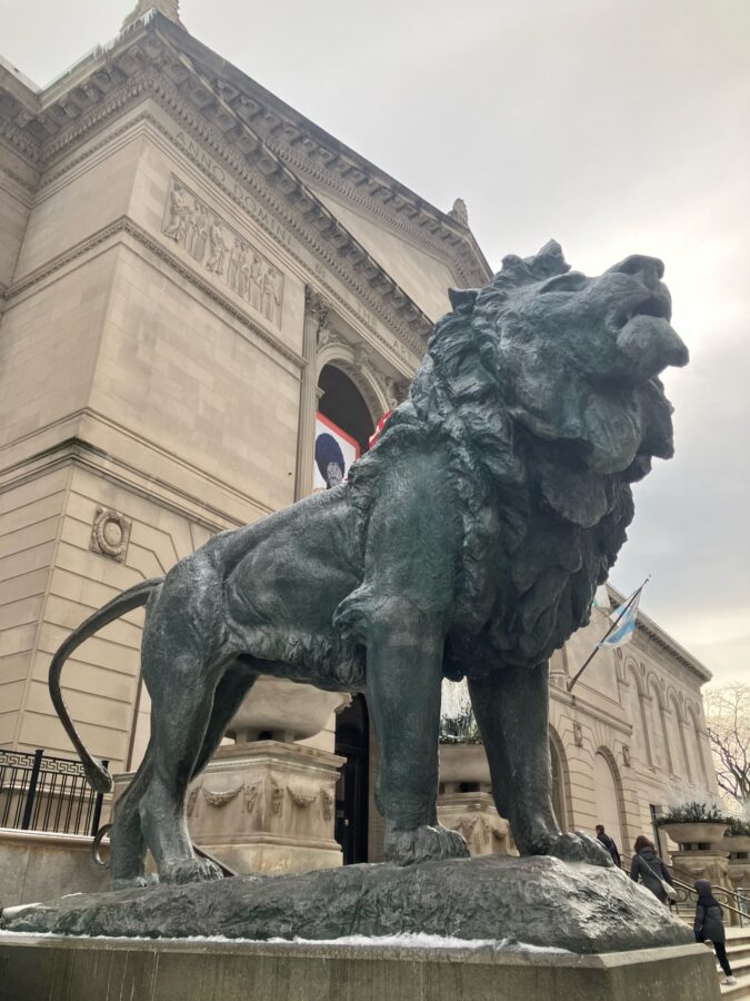 Bronze lion on pedestal in front of Michigan Avenue entrance to the Art Institute of Chicago.