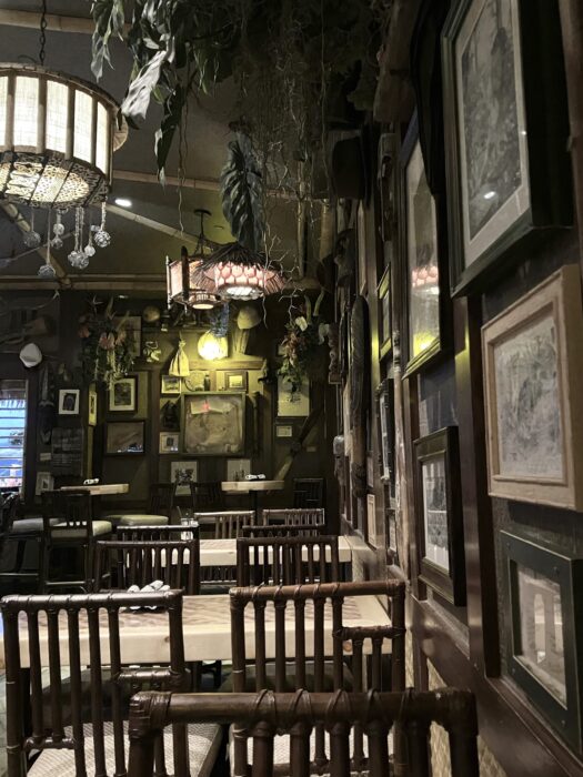 Photo of tables and cheers in the interior of Trader Sam’s Enchanted Tiki Bar surrounded by themed decor.