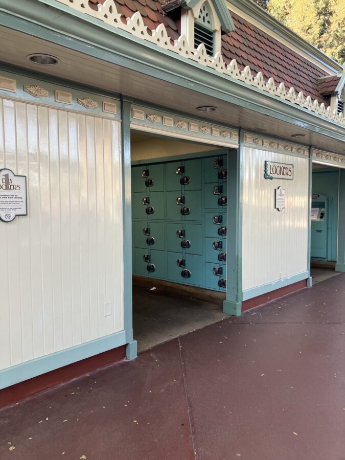 Photo showing shiny white exterior to locker area in Esplanade of Disneyland Resort. Inside are teal blue lockers.